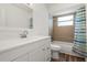 Bathroom with white vanity, and bathtub with tiled walls and a modern shower curtain at 1505 Guinevere Dr, Casselberry, FL 32707