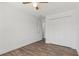 Bright bedroom featuring wood-look floors, closet and neutral walls, for versatile style at 1505 Guinevere Dr, Casselberry, FL 32707