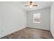 Sunlit bedroom with wood-look flooring and a view from the large window at 1505 Guinevere Dr, Casselberry, FL 32707