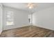 Inviting bedroom featuring warm wood-look flooring, multiple windows and ample natural light at 1505 Guinevere Dr, Casselberry, FL 32707