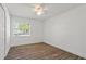 Well-lit bedroom with wood-look flooring and a large window at 1505 Guinevere Dr, Casselberry, FL 32707