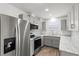 Modern kitchen featuring stainless steel appliances, sleek gray cabinets, and light countertops at 1505 Guinevere Dr, Casselberry, FL 32707