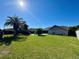 Backyard view features lawn, trees, pool, and the exterior of the home at 1509 Jason St, Kissimmee, FL 34744