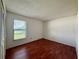 Bedroom with wood floors, a window with blinds, and a closet at 1509 Jason St, Kissimmee, FL 34744