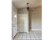 Bright entryway featuring tile flooring, a coat closet, and a white front door at 1509 Jason St, Kissimmee, FL 34744