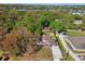 Aerial view of a charming single-story home featuring a long drive and lush greenery at 1518 Coletta Dr, Orlando, FL 32807