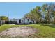 View of back exterior, yard and driveway at 1518 Coletta Dr, Orlando, FL 32807