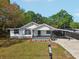 Home featuring a covered front porch and driveway at 1518 Coletta Dr, Orlando, FL 32807