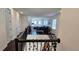 Foyer showcasing black staircase railings and a view of the living room below with a decorated Christmas tree at 15742 Vetta Dr, Bella Collina, FL 34756