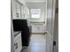 Well-organized laundry room with sleek black washer/dryer and ample white cabinet storage at 15742 Vetta Dr, Bella Collina, FL 34756