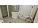 Main bathroom features a soaking tub, glass shower, and granite countertops at 15742 Vetta Dr, Bella Collina, FL 34756