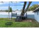 Backyard area with a tree swing and an elevated deck that is constructed around the trunk of a mature tree at 1610 Stephanie Ln, Lakeland, FL 33813