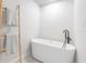 Minimalist bathroom design featuring a modern tub, matte black faucet, and ladder towel rack at 1610 Stephanie Ln, Lakeland, FL 33813