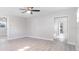 Large bedroom with wood-look flooring, neutral walls, a ceiling fan and open closet at 1610 Stephanie Ln, Lakeland, FL 33813