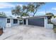 Home exterior showcasing a large garage, driveway, and light blue siding at 1610 Stephanie Ln, Lakeland, FL 33813