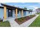 Cozy front porch featuring wooden support columns and patterned concrete that is surrounded by flower beds at 1610 Stephanie Ln, Lakeland, FL 33813