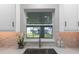 Kitchen sink with quartz counters, tile backsplash, and window view at 1610 Stephanie Ln, Lakeland, FL 33813