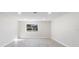 Spacious living room featuring light-colored laminate wood flooring and a window at 1610 Stephanie Ln, Lakeland, FL 33813