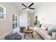 Bright living room featuring a ceiling fan, modern furnishings, and ample natural light from large windows at 1610 Stephanie Ln, Lakeland, FL 33813