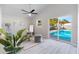 Bright living room with pool view, vaulted ceilings, ceiling fan, and light wood-look floors at 1610 Stephanie Ln, Lakeland, FL 33813