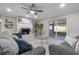 Living room with a fireplace, grey sofa, glass coffee table and screened in lanai at 1610 Stephanie Ln, Lakeland, FL 33813