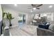 Bright living room with grey sofa, glass coffee table, screened lanai and open kitchen at 1610 Stephanie Ln, Lakeland, FL 33813