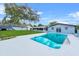 Refreshing swimming pool with ladder entry, surrounded by a concrete patio and lush green backyard at 1610 Stephanie Ln, Lakeland, FL 33813