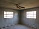 Unfurnished bedroom with two windows and a ceiling fan, awaiting transformation at 1838 Windmill Dr, Orlando, FL 32818