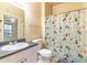 Cozy bathroom featuring a vanity with a sink, toilet, and a shower with a fun curtain at 19920 Villa Ridge Dr # 206, Orlando, FL 32821