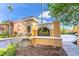 Community entrance with elegant signage, lush landscaping, and a fountain adding a touch of class at 19920 Villa Ridge Dr # 206, Orlando, FL 32821