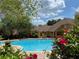 Sparkling pool surrounded by lush bougainvillea, offering a refreshing oasis for relaxation and recreation at 19920 Villa Ridge Dr # 206, Orlando, FL 32821