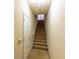 Carpeted stairway leading upstairs, offering a transition between floors of the home at 19920 Villa Ridge Dr # 206, Orlando, FL 32821