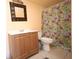 Bathroom featuring toilet, floral shower curtain and wood-look vanity at 209 Esplanade Way # 109, Casselberry, FL 32707