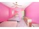 Cozy pink bedroom with ceiling fan, mirrored closet, and tile flooring at 209 Esplanade Way # 109, Casselberry, FL 32707