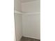 A closet with a partial shelf and laminate flooring at 209 Esplanade Way # 109, Casselberry, FL 32707