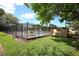 Fenced outdoor community pool with chairs, tables and manicured lawn on a sunny day at 209 Esplanade Way # 109, Casselberry, FL 32707