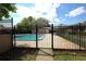 Fenced outdoor community pool with chairs, tables and manicured lawn on a sunny day at 209 Esplanade Way # 109, Casselberry, FL 32707