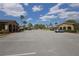 Parking lot with two buildings, Palm trees and multiple parked cars at 209 Esplanade Way # 109, Casselberry, FL 32707