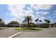 Community landscaped roundabout with palm trees on a sunny day with single story residential buildings in the background at 209 Esplanade Way # 109, Casselberry, FL 32707