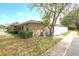 Side exterior of a well maintained house with a white fence under a partly cloudy blue sky at 209 Esplanade Way # 109, Casselberry, FL 32707