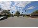 Scenic street view featuring well-maintained homes, mature trees, and parked cars under a clear sky at 209 Esplanade Way # 109, Casselberry, FL 32707