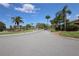 Street view of the community with palm trees and landscaped lawns on a sunny day at 209 Esplanade Way # 109, Casselberry, FL 32707