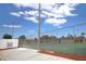 Fenced outdoor community tennis courts with green surface on a sunny day at 209 Esplanade Way # 109, Casselberry, FL 32707