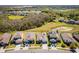 An aerial shot captures several homes, each with driveways, solar panels, and fenced yards at 2300 Natoma Blvd, Mount Dora, FL 32757