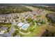 Wide aerial view of community featuring a pool, clubhouse, lawns and neatly lined houses at 2300 Natoma Blvd, Mount Dora, FL 32757