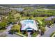 Aerial view highlighting community pool, lawns, parking, and a picturesque view at 2300 Natoma Blvd, Mount Dora, FL 32757
