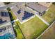 Aerial view of the backyard reveals a lush lawn, solar panels, and a securely fenced perimeter at 2300 Natoma Blvd, Mount Dora, FL 32757