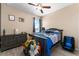 Bedroom with stylish blue accents, plush toys, and dark wood dresser with hardwood-style floors at 2300 Natoma Blvd, Mount Dora, FL 32757