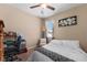 Cozy bedroom featuring a ceiling fan, large window, and a comfortable bed with stylish accents at 2300 Natoma Blvd, Mount Dora, FL 32757