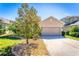 Frontal view of house with a well-kept lawn and a stone-mulched garden at 2300 Natoma Blvd, Mount Dora, FL 32757